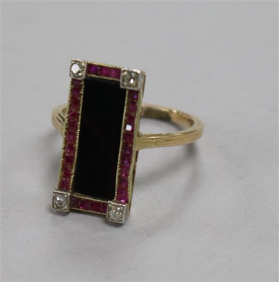 An Austro-Hungarian yellow metal, black onyx, ruby and diamond set tablet ring, size K.